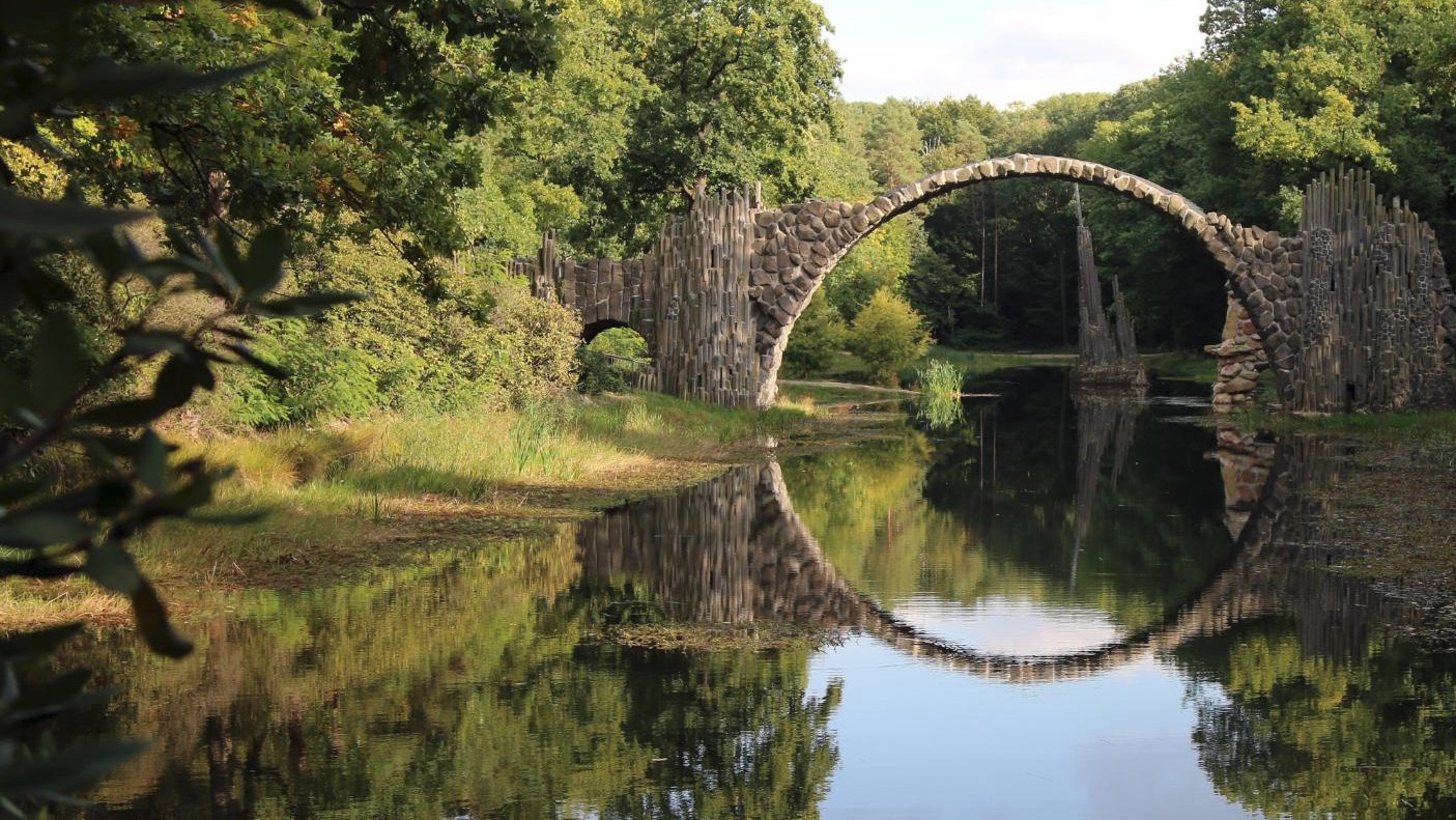 The Rakotzbrücke, also known as Devil's Bridge, reflecting perfectly in the water